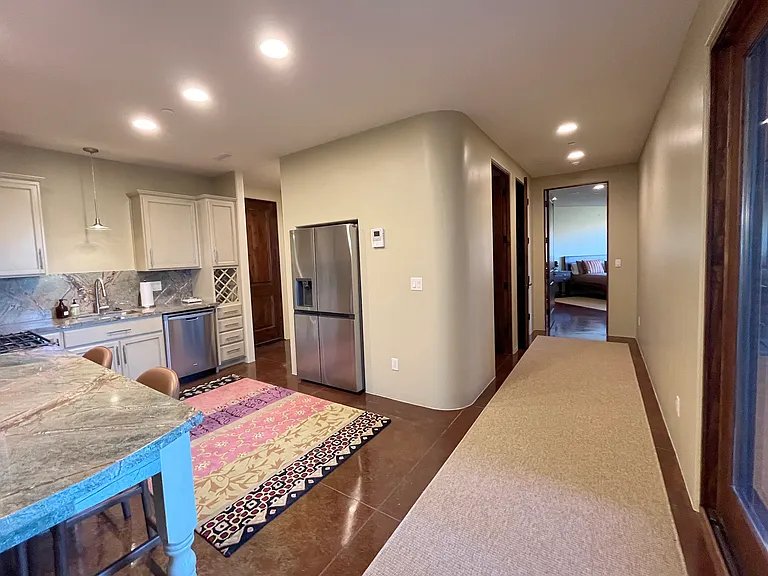 Hall to Master Suite 3 with Kitchen and Hallway to Elevator on the Left