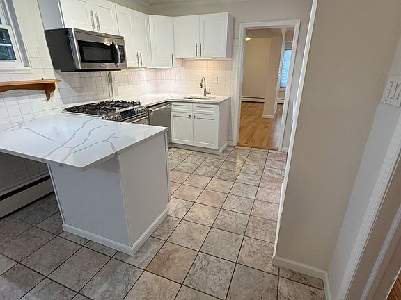 View from Kitchen to Spacious Living Room.
