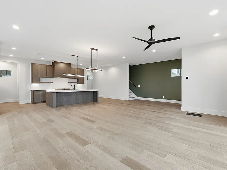 Spacious main living area space with contemporary design, oversized layout, and stylish accent wall.