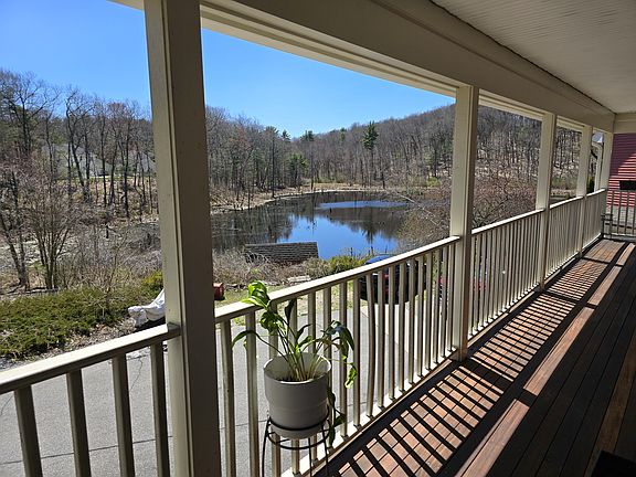 Covered rear porch with fantastic views of Brookside Pond. Great Bird Watching!