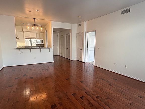 LIVING ROOM, KITCHEN & ENTRANCE TO PRIMARY SUITE