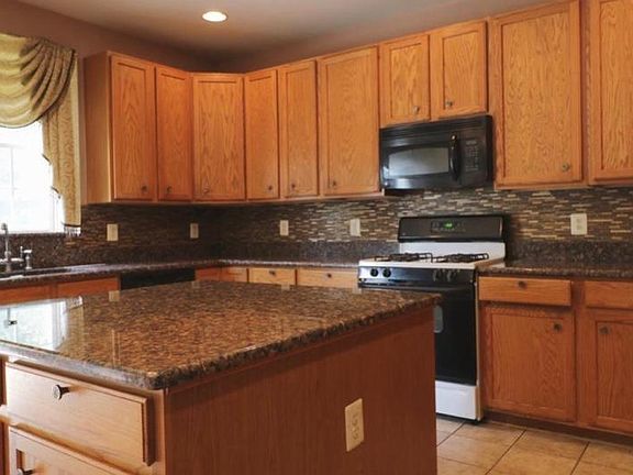 Kitchen with granite countertops and granite sink