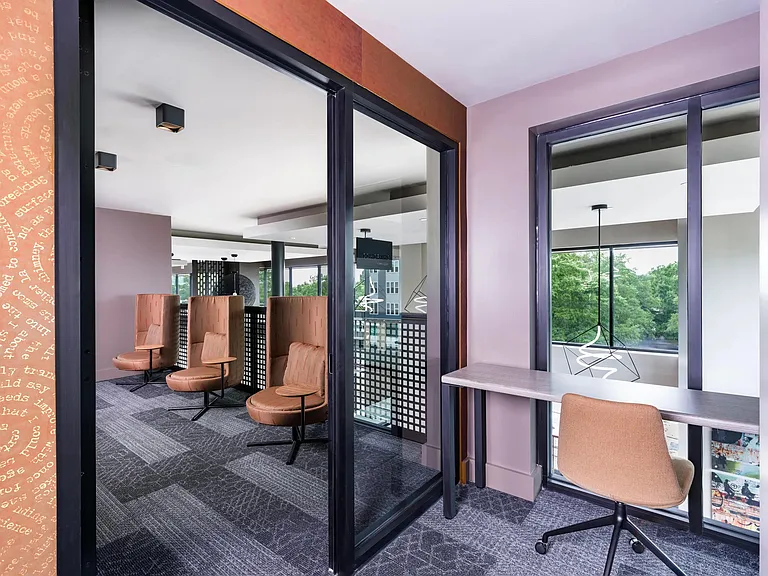 Coworking spaces with comfortable seating areas and private workstations.