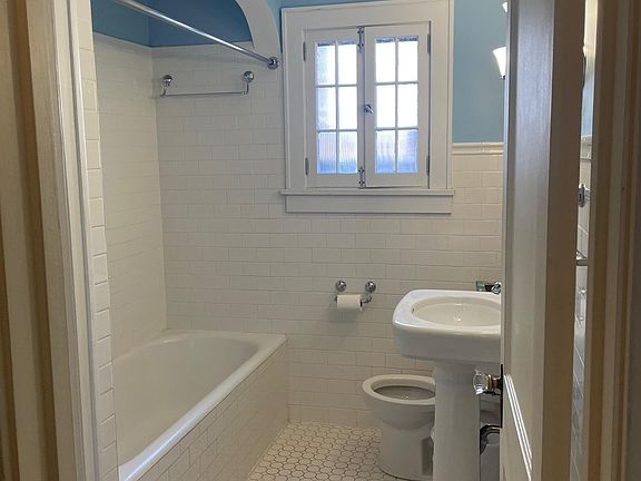 Main floor full bathroom with linen closet