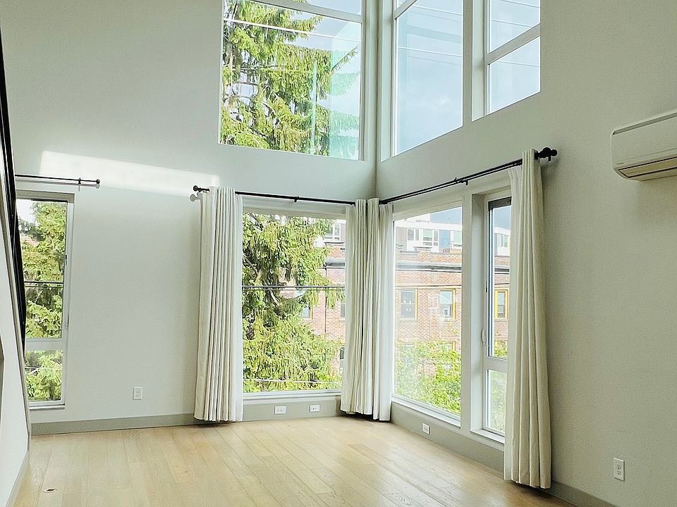 Floor to ceiling windows in southeast-facing living room, filled with natural light all year round!