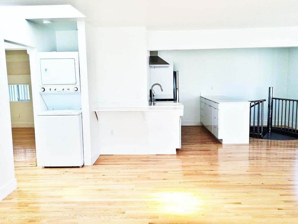 Upper level kitchen with iron staircase