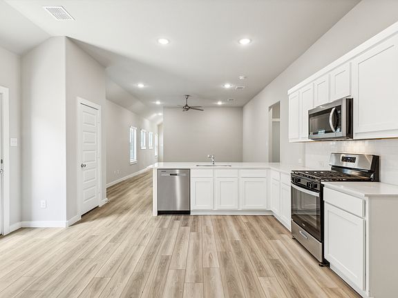 Kitchen in the Pecan home plan by Trophy Signature Homes - REPRESENTATIVE PHOTO