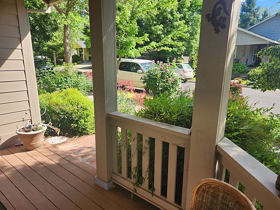 Lovely covered deck in front of private corner house.