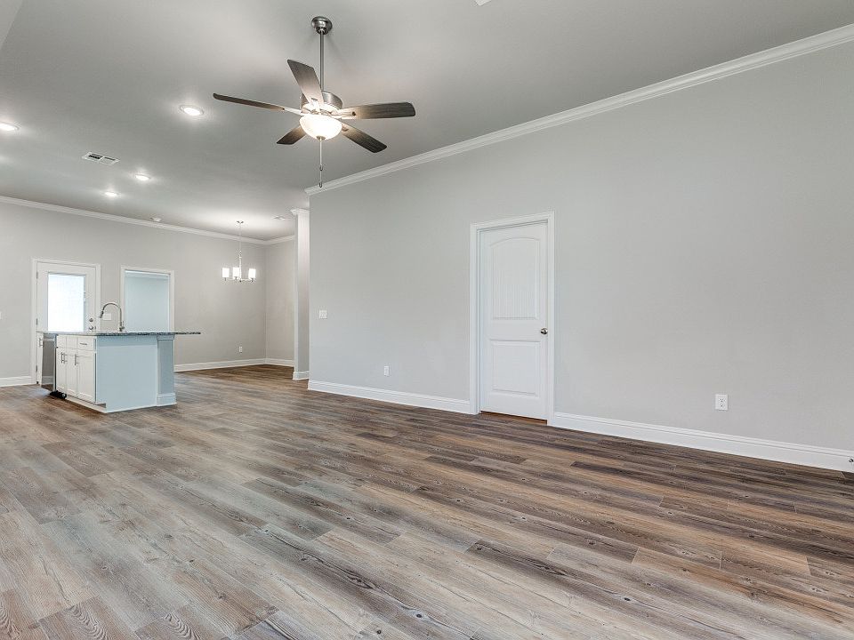 Bright living room with open layout connected to kitchen.