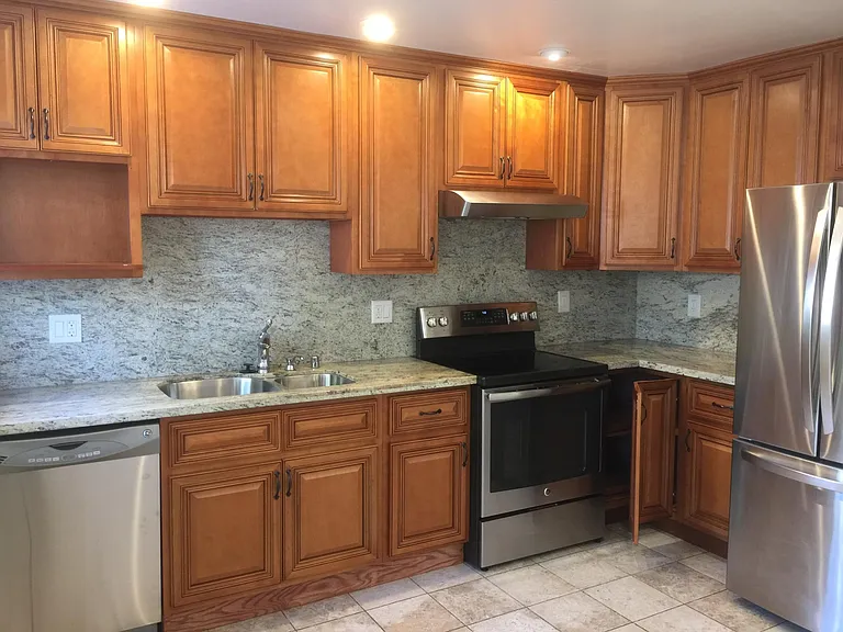 new kitchen, all stainless steel appliances and double sink, granite countertop, lazysusan shelves at the corner