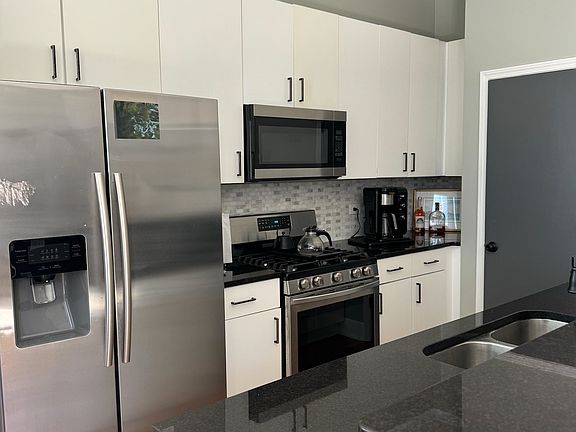 Kitchen - full sized refrigerator, microwave and gas oven range