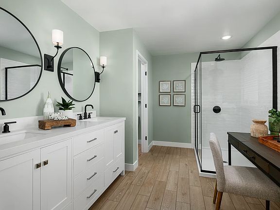Primary bath with matte black fixtures and mirrors