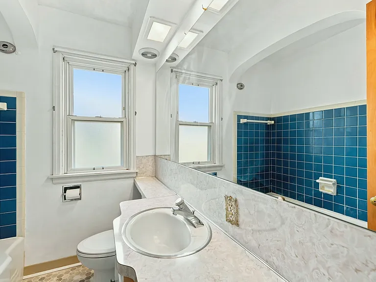 Bathroom with full bath, brand new flooring, cabinet storage, and newly installed exhaust fan.