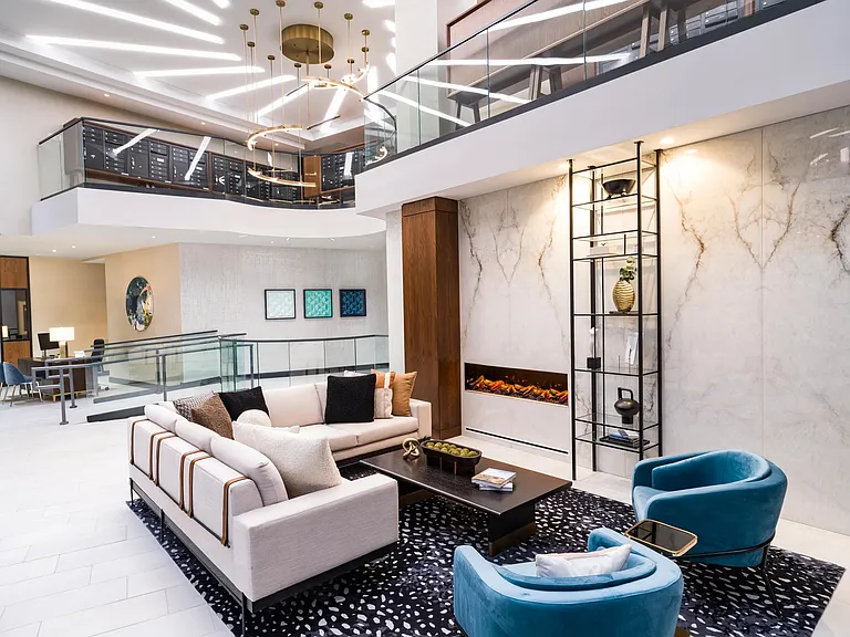 A refined leasing lobby lounge at Modera McGavock, where layered lighting and modern design welcome you home.