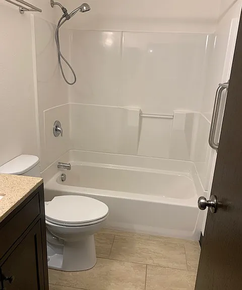 bath with nice porcelain flooring