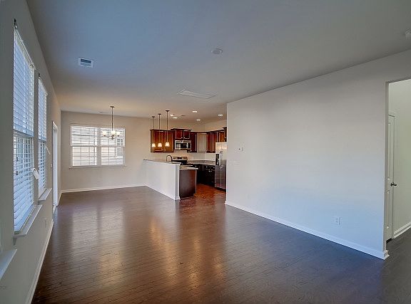 Large open family room with beautiful wood floors.