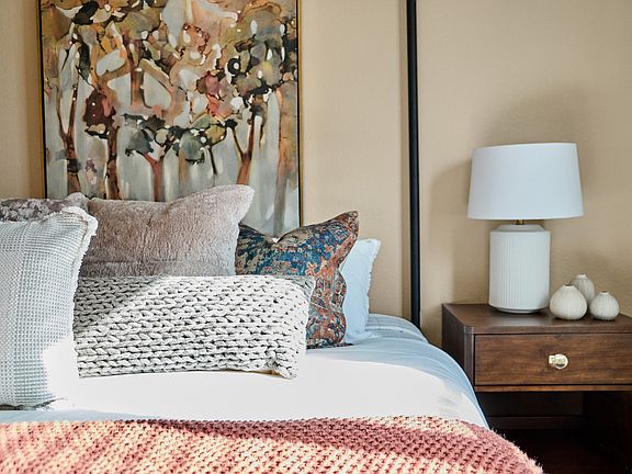 The secondary bathroom has carpet and a large window.