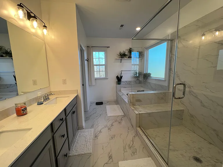 Primary with glass walk in shower with bench
