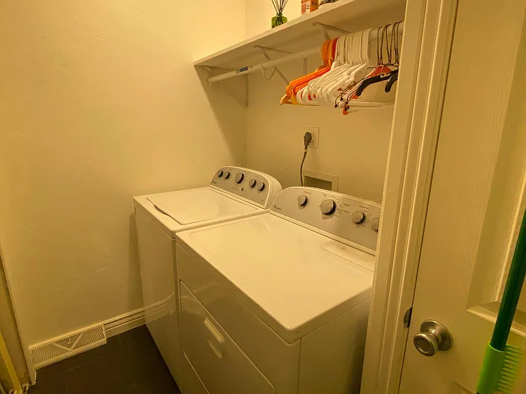 washer dryer in home, large shelves on opposite wall