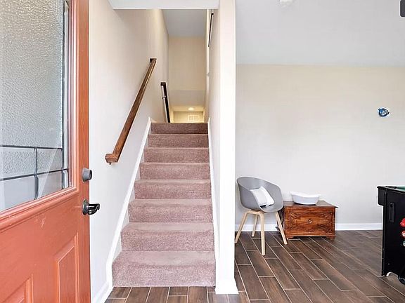 Entryway from front door into recreational room / flex space. Across the steps is access to the rear facing 2 car garage