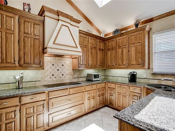 Remodeled kitchen. Solid Oak Cabinets. Custom vent hood.