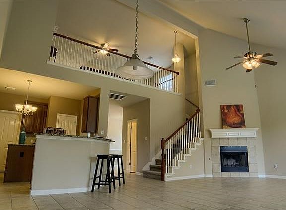 The light, airy character of the double height living area enhances the home's spacious look, while the kitchen's open-plan design allows the cook to chop, stir and socialize all at once!