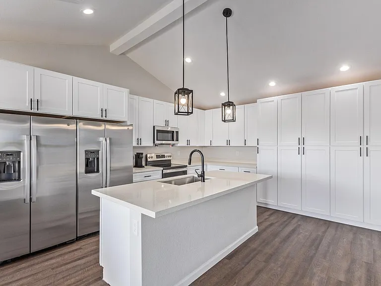 Brand new kitchen with two refrigerators, island, and plenty of storage.