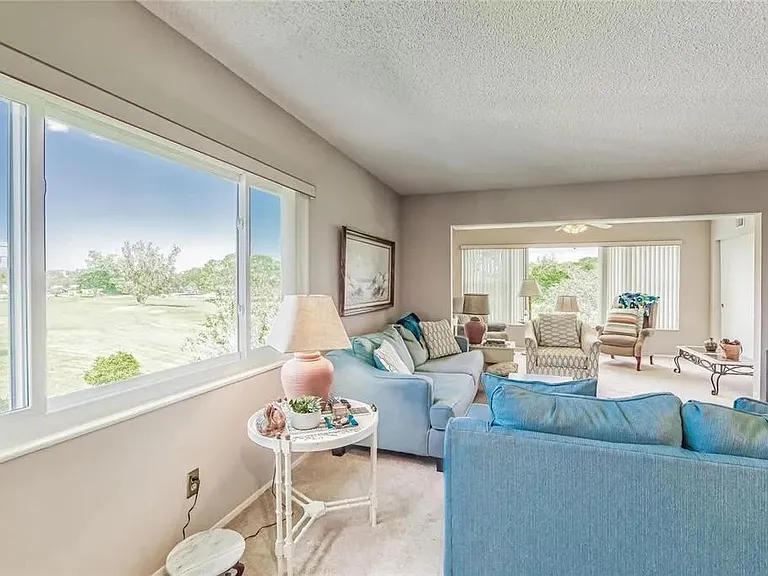 Living Room with side window view of golf course.

 *This unit is unfurnished. All furniture has been removed.