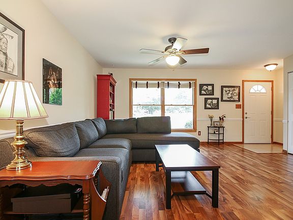 Large living room with laminate wood flooring.