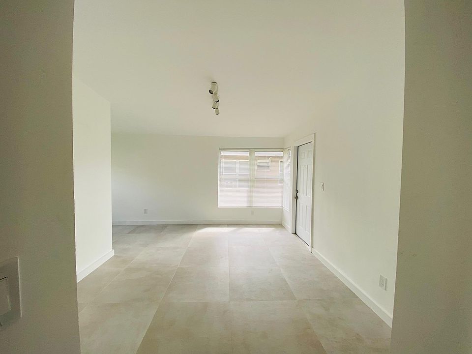 Living room with LED lights and large porcelain tile.