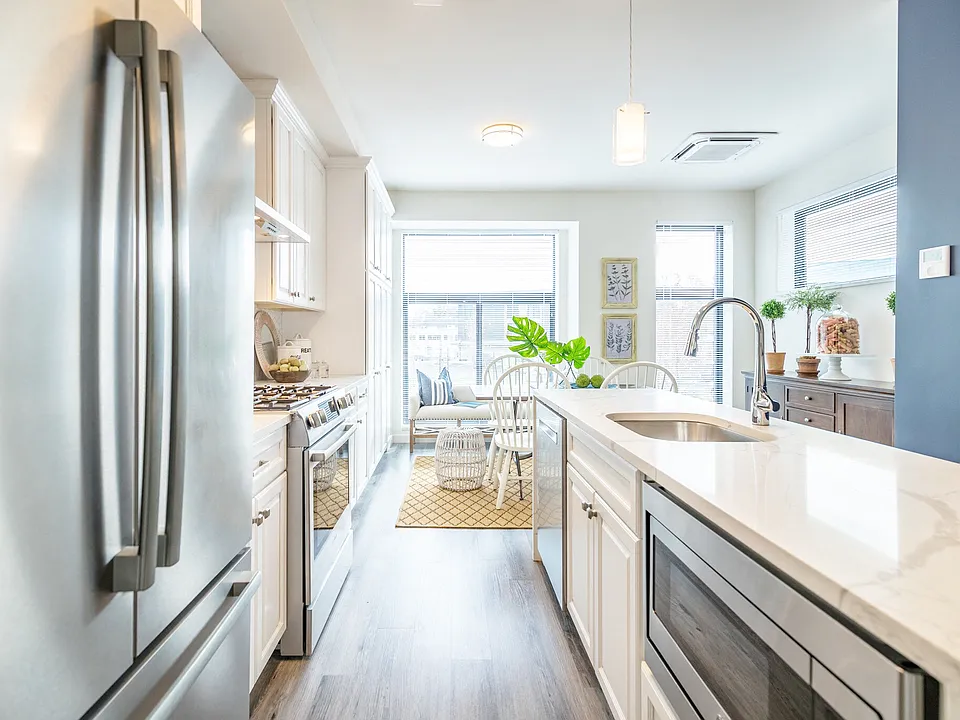 White Cabinets with brushed nickel pulls and Stainless Steel Appliance Package