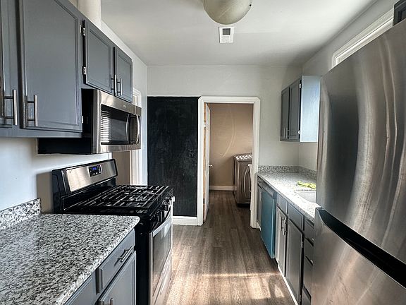 Kitchen with gas stove, dishwasher, microwave and refrigerator