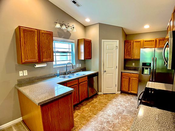 Double sink, disposal, dishwasher. The window opens to side of yard.