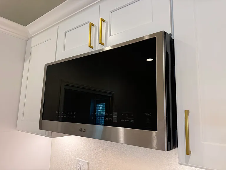 Premium LG Smart over-the-range microwave seamlessly integrated into the custom cabinetry.