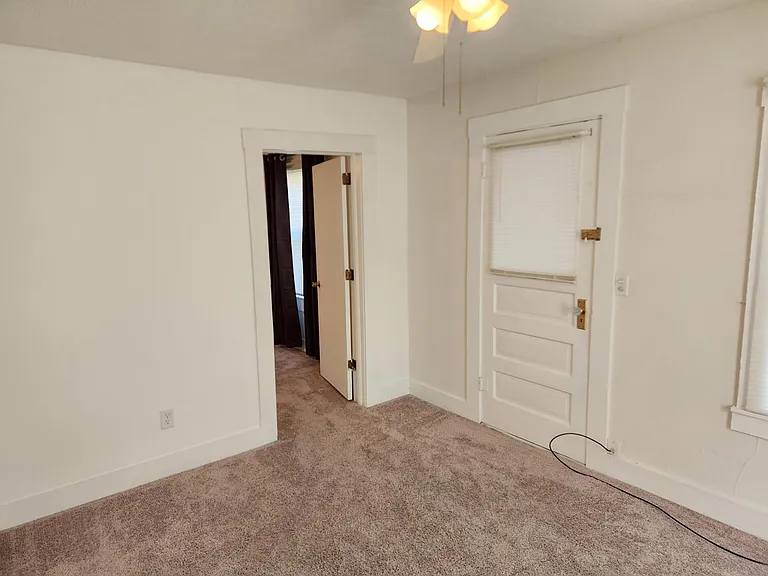 Door on left leads to main bedroom. Door on right leads to a small front porch (not shown) and then to front exterior door.