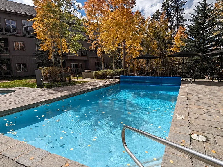 Large heated pool with a deep end and insulated night cover.
