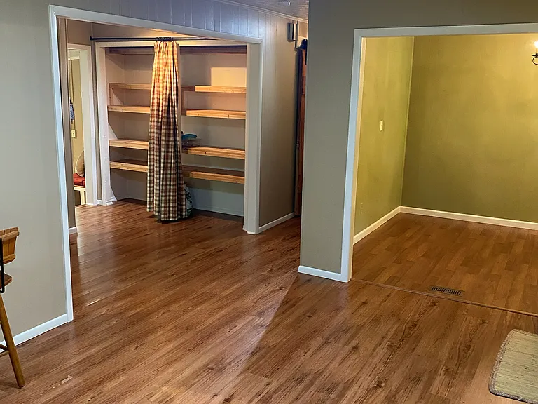 Pantry on left, dining area on the right, looking from the living room area.