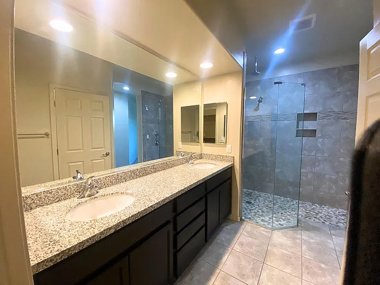 Primary bath with huge vanity, dual sinks, 2 mirrored medicine cabinets, huge walk-in shower with Rain shower head & second shower head.