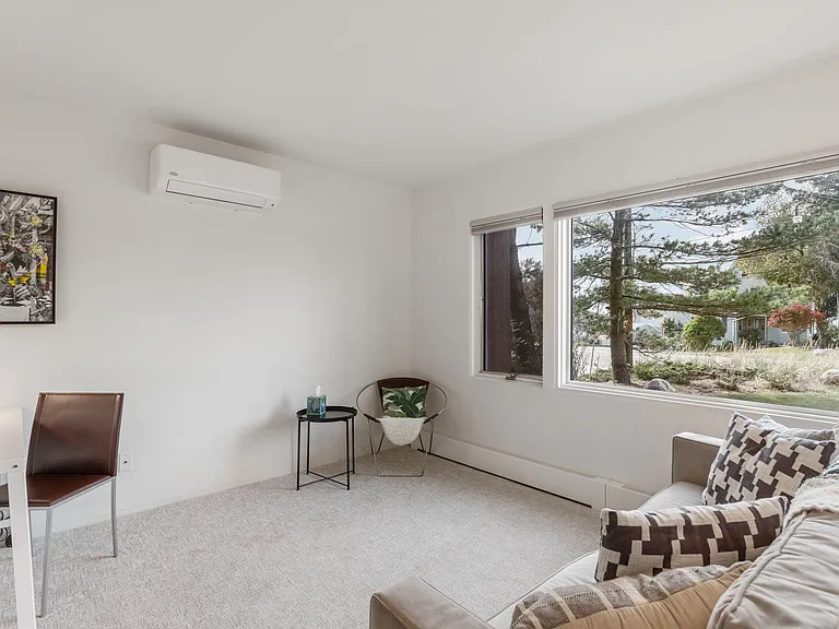 Sitting room on ground floor with pullout sofa, desk