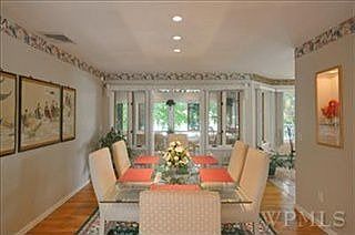 Formal dining room with custom built-ins and spectacular view of lake.