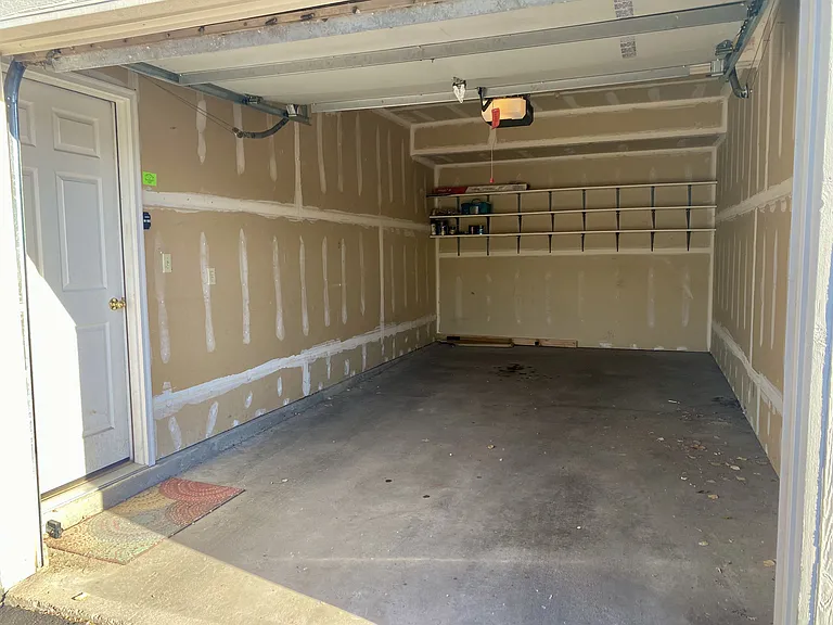 Private attached garage with storage space and direct access to the home.