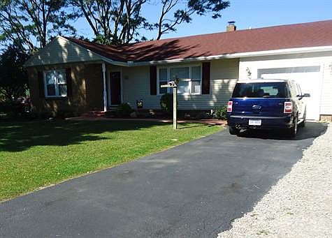 Attached garage with additional stoned parking area