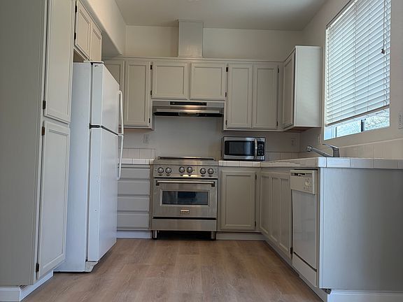 Newly remodeled kitchen with freshly painted cabinets, new flooring, appliances & ceiling fixture!