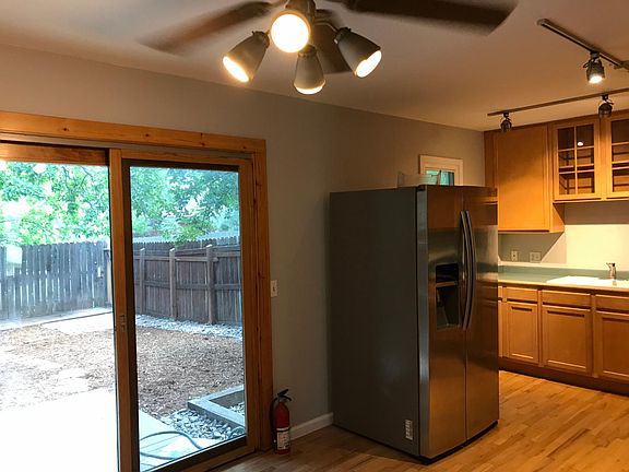 Sliding door in dining area leading to private fenced backyard