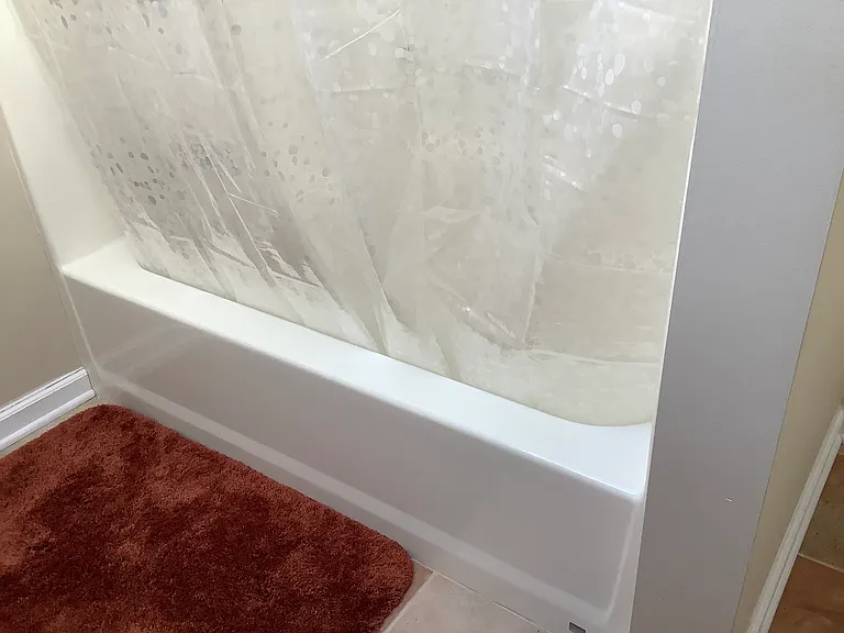 Bathtub with a shower.