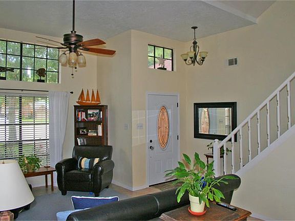 A view of the pretty entry, living room with it's soaring ceilings, new light fixtures and freshly painted interior.