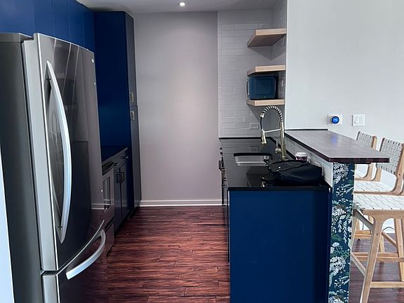 Open kitchen with breakfast bar and stainless steel appliances