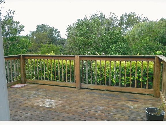 rear fenced yard, view off deck