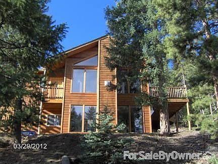 Front of House
						:
						Cedar siding, composite shingle roof, walls of windows