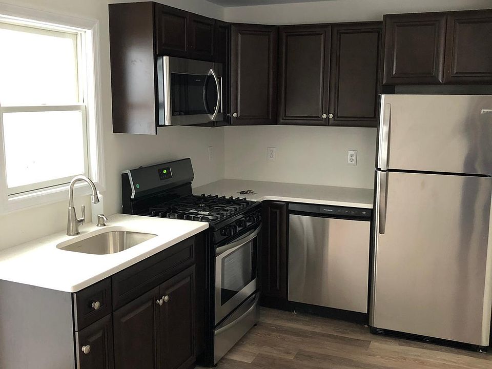 Stainless Steel appliances, new floors, white granite, expresso cabinets